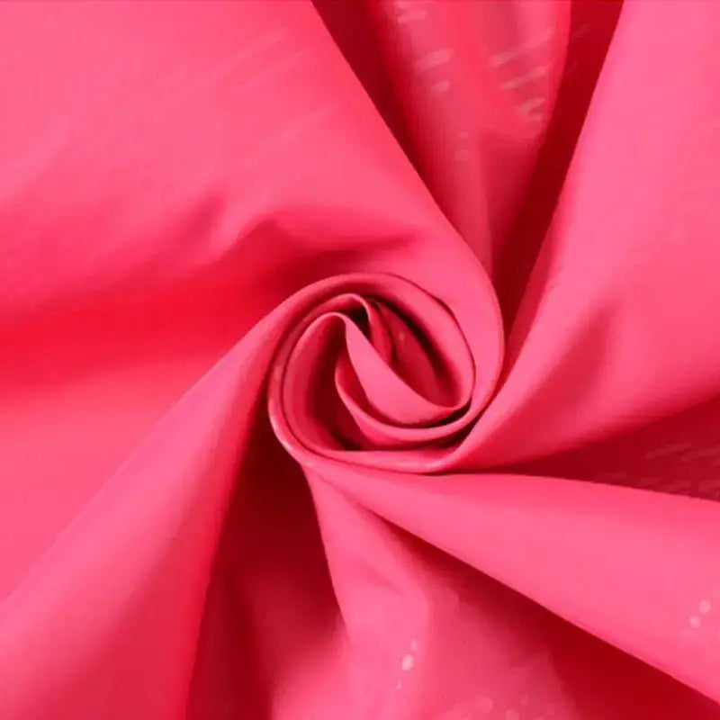 Close-up of durable fabric for affordable rain gear in vibrant pink color