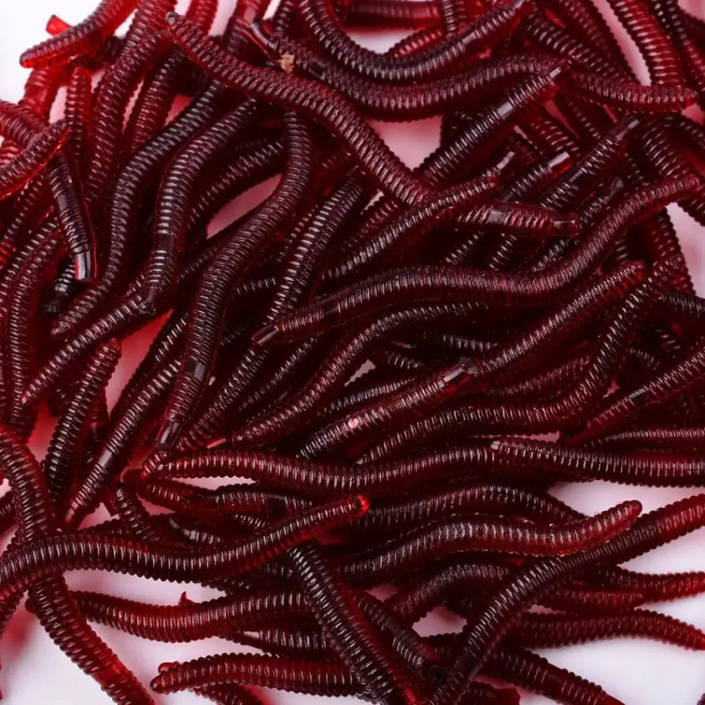 Collection of artificial earthworms for fishing in realistic red color, ideal for attracting various fish species