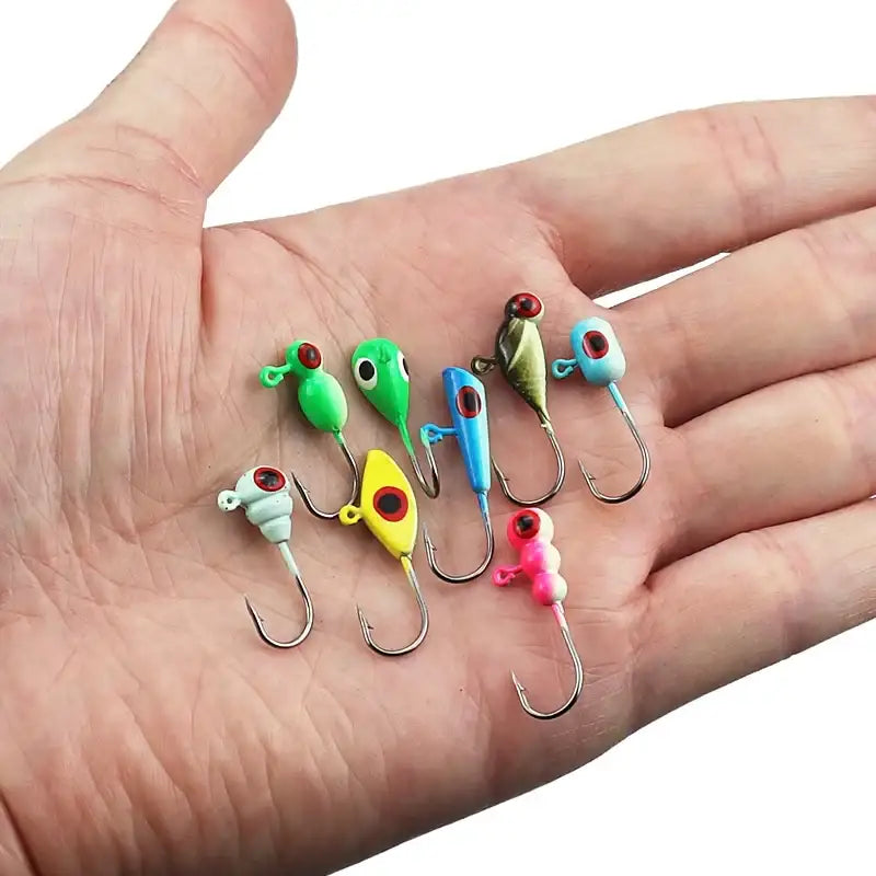 A selection of colorful ice fishing jigs displayed on a hand, ideal for winter fishing