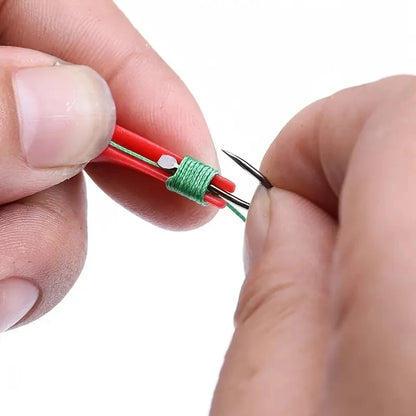 A close-up of a hand using a dual purpose fishing hook remover for easy hook removal