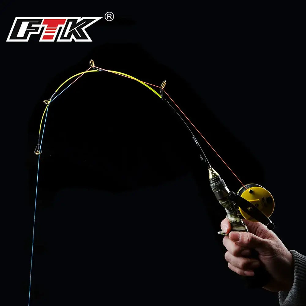 FTK Ice Fishing Rod and Reel Combo held by a person with a curved line for catching fish