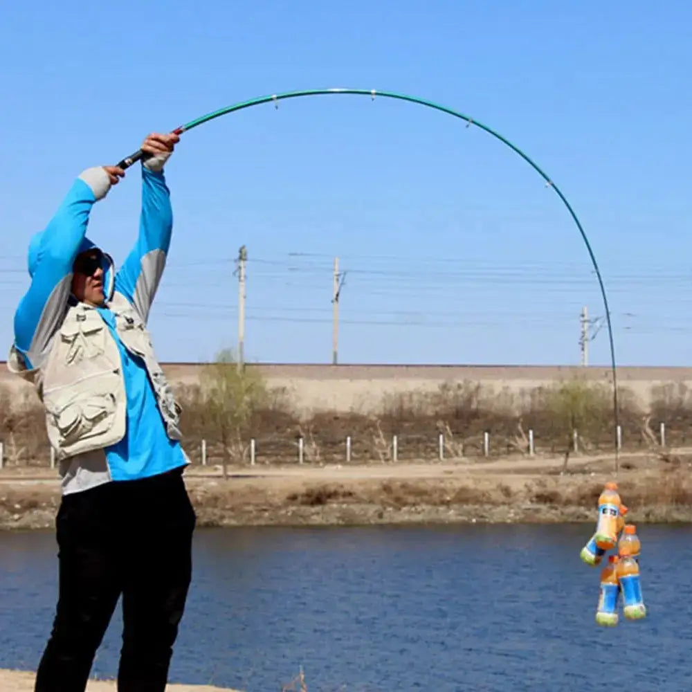 Ghotda collapsible fishing rod in use by an angler near a river with a toy catch