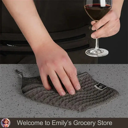Hand reaching for super absorbent fishing towels on a table next to a glass of wine