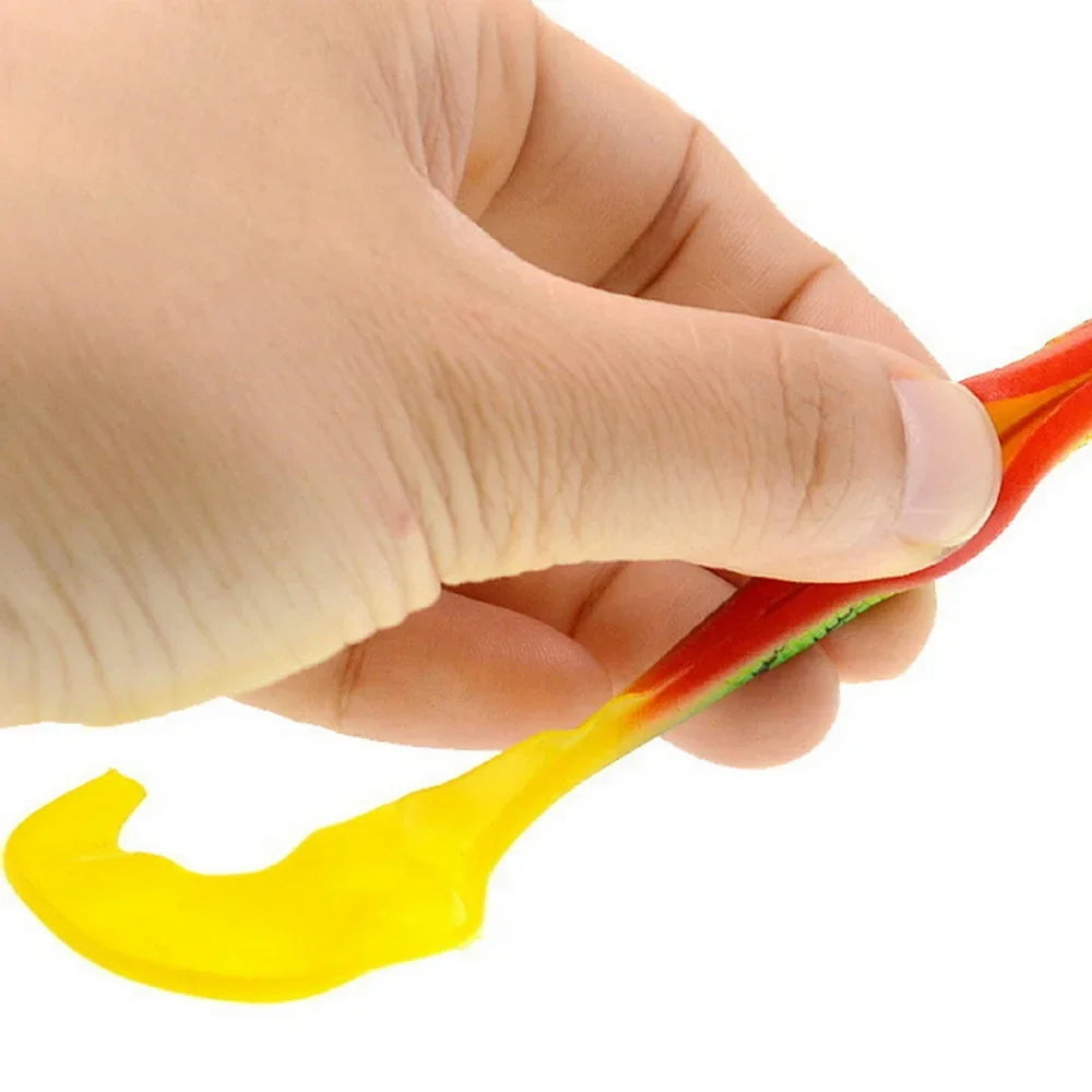 Hand holding a vibrant T-tail fishing lure in red and yellow for effective fishing