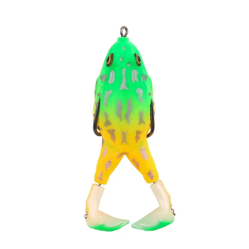 Green and yellow topwater frog lure for bass fishing with detailed eyes and flexible legs